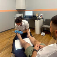 Patient receiving podiatry Woodville treatment from a skilled podiatrist providing foot care, pain relief, orthotic support, and podiatric care for plantar fasciitis, bunions, heel pain, sports injuries, ingrown toenail, warts, and feet conditions.